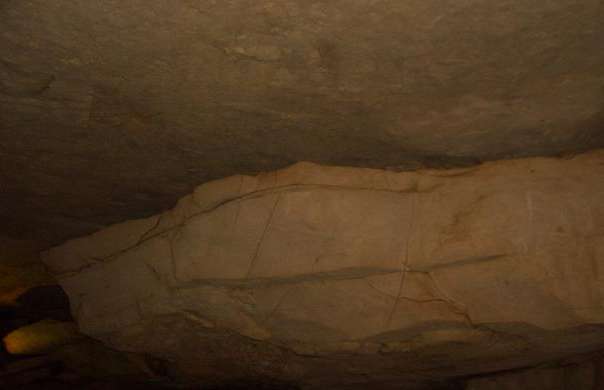A flat ceiling being formed piece by falling piece in one of the rooms of the cave