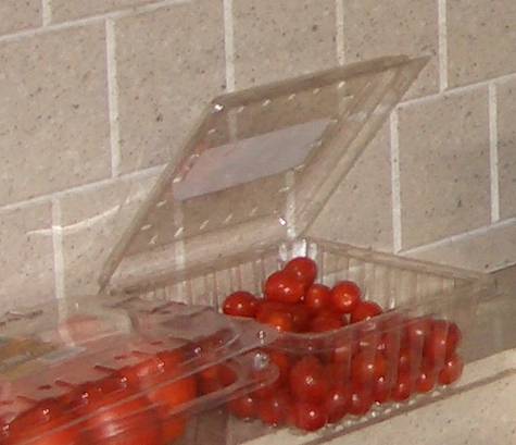 Container of mostly eaten tomatoes