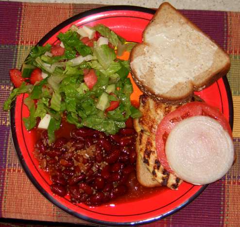 Pounded chicken sandwich with southwestern beans and salad