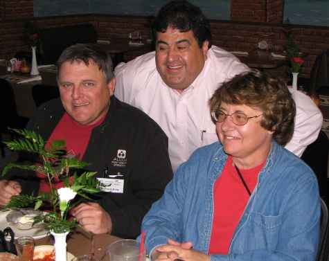 Old man with young chick and restaurateur